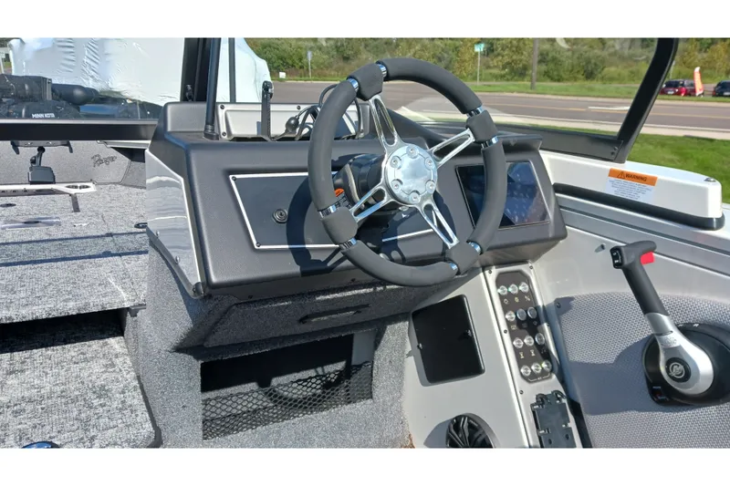 Slide: The Image of 2025 Ranger VX1988 WT boat dashboard with steering wheel and control panel. - 7