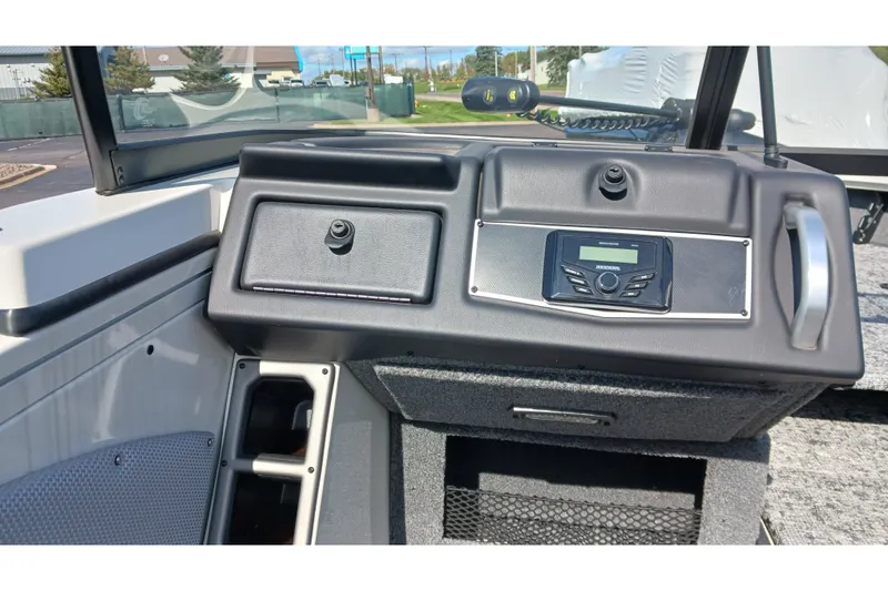 Slide: The Image of 2025 Ranger VX1988 WT boat dashboard with control panel and storage compartments. - 5