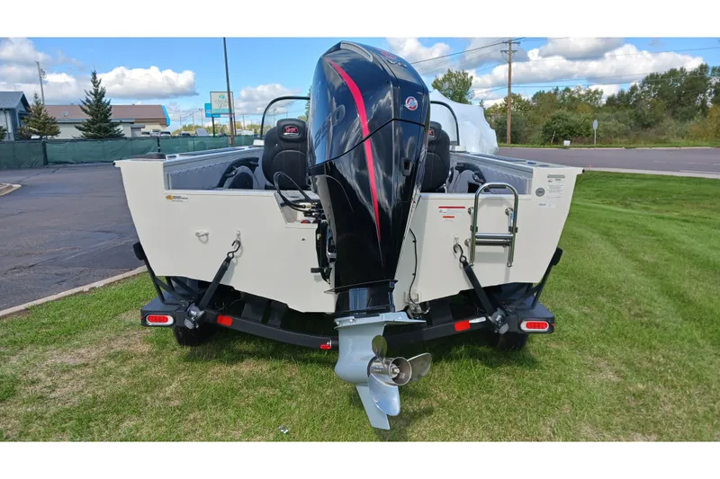 Slide: The Image of 2025 Ranger VX1988 WT boat with powerful outboard motor on grassy area. - 2