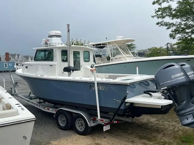 The Image of 2022 Parker 2520 XLD Sport Cabin boat on trailer with Yamaha engine. - 1
