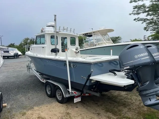 Slide: The Image of 2022 Parker 2520 XLD Sport Cabin boat on trailer with Yamaha engines. - 10