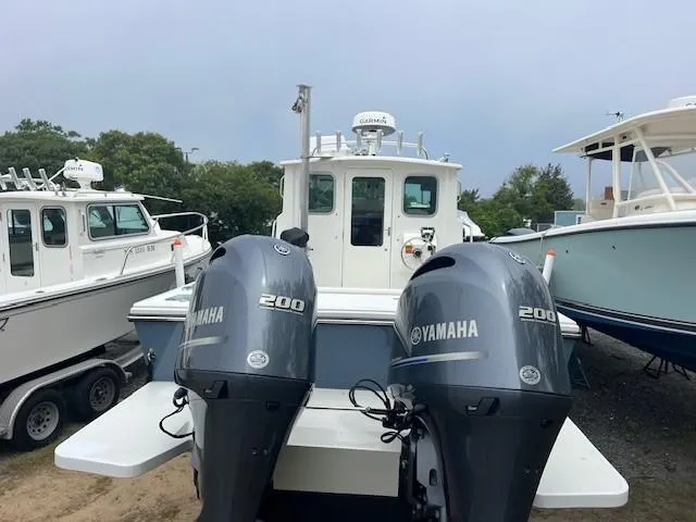 Slide: The Image of 2022 Parker 2520 XLD Sport Cabin with dual Yamaha 200 engines, docked outdoors. - 9