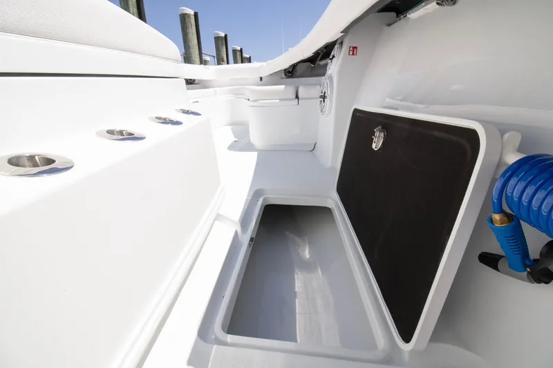 Slide: The Image of 2026 Yellowfin 36 Offshore boat interior with storage compartment and rod holders. - 10