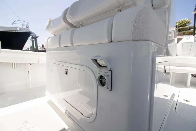 Slide: The Image of 2026 Yellowfin 36 Offshore boat interior with white seating and storage compartment. - 14
