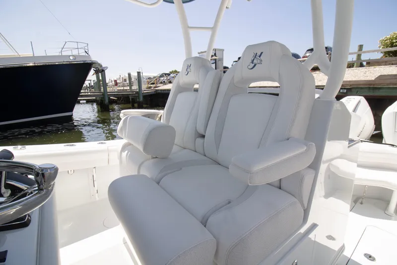 Slide: The Image of 2026 Yellowfin 36 Offshore boat with luxurious white seating at a marina. - 15