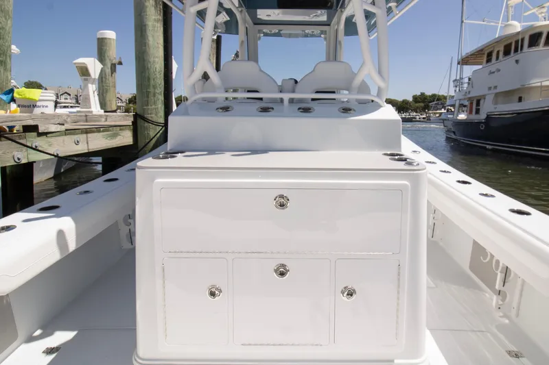 Slide: The Image of 2026 Yellowfin 36 Offshore boat interior with storage compartments at a marina. - 19