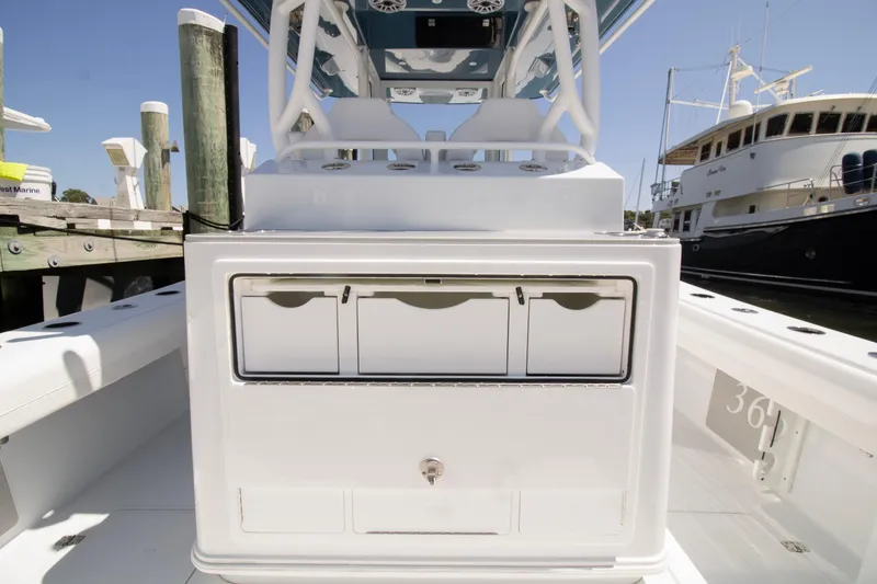 Slide: The Image of 2026 Yellowfin 36 Offshore boat interior with storage compartments at a marina. - 21