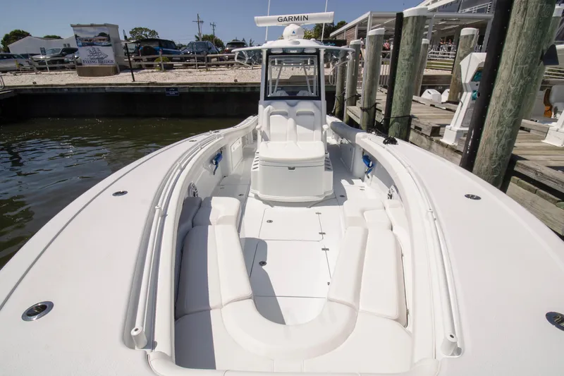 Slide: The Image of 2026 Yellowfin 36 Offshore boat docked, featuring spacious seating and Garmin navigation. - 4