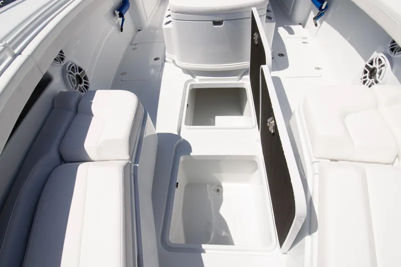 Slide: The Image of 2026 Yellowfin 36 Offshore boat interior with open storage compartments and cushioned seating. - 5