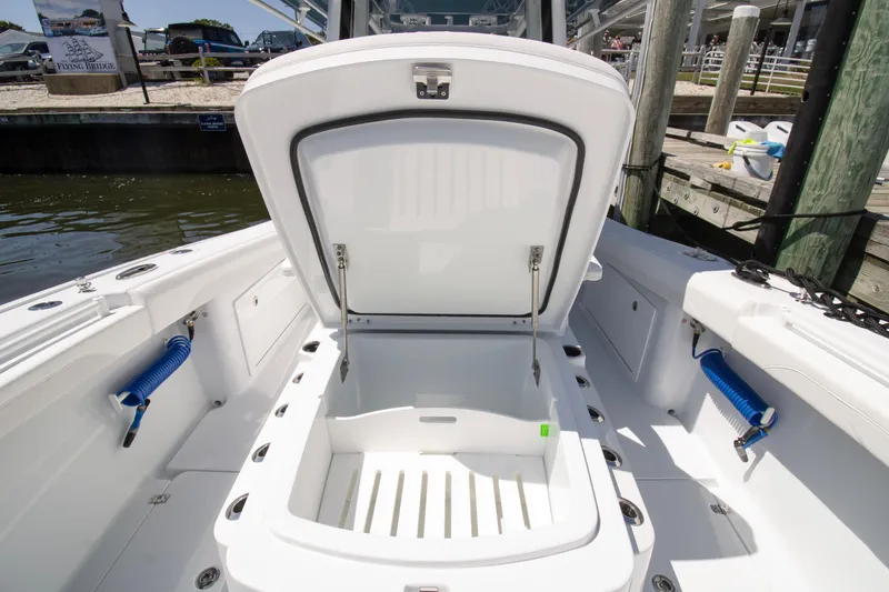 Slide: The Image of 2026 Yellowfin 36 Offshore boat with open storage compartment at dockside. - 7