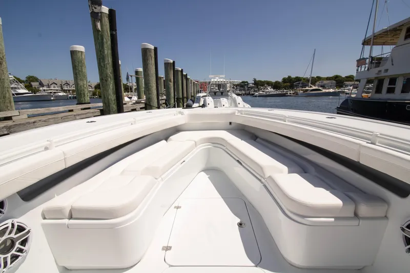 Slide: The Image of 2026 Yellowfin 36 Offshore boat docked, featuring spacious seating and sleek design. - 9