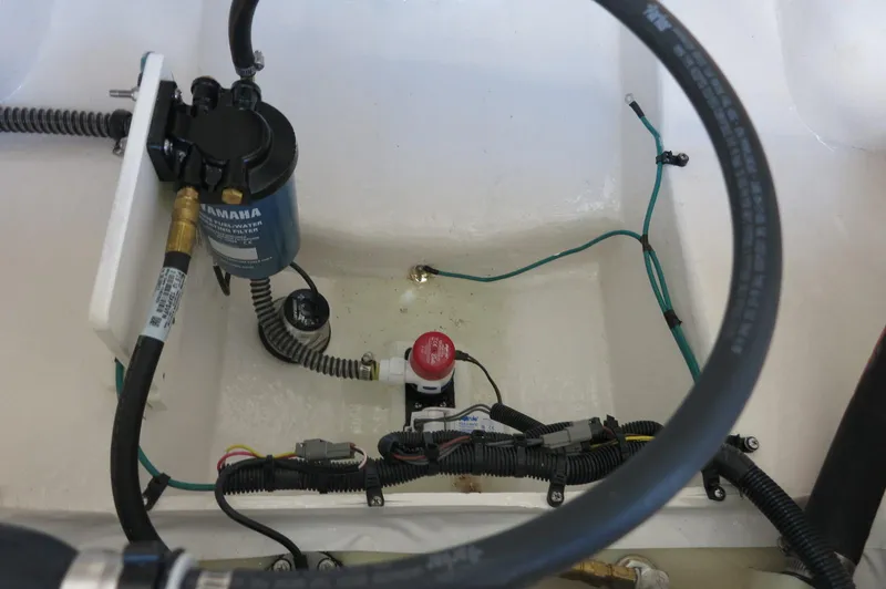 Slide: The Image of 2025 Chaparral 21 SSi Outboard engine compartment with Yamaha components and wiring. - 12