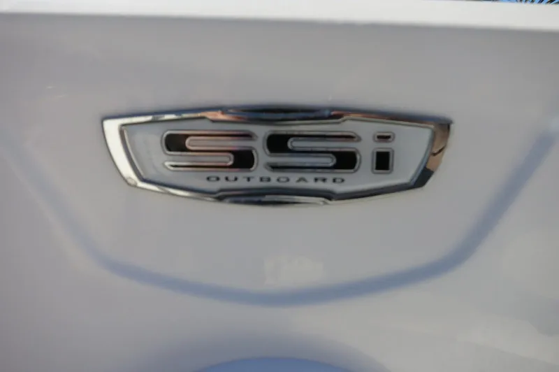 Slide: The Image of 2025 Chaparral 21 SSi Outboard emblem on a sleek white surface. - 24