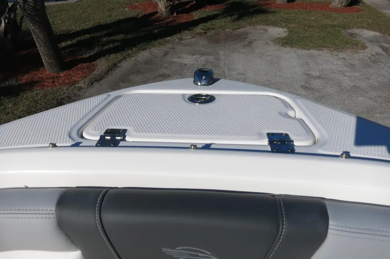 Slide: The Image of 2025 Chaparral 21 SSi Outboard boat bow with storage compartment and sleek design. - 26