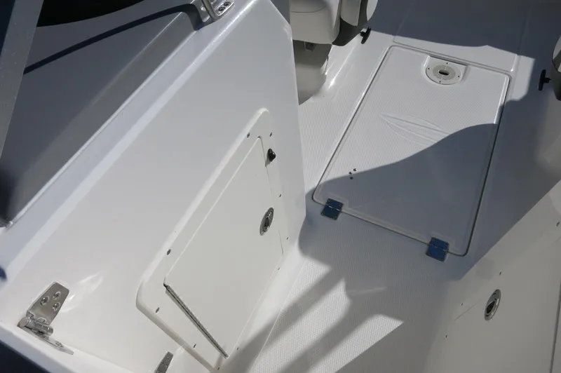 Slide: The Image of 2025 Chaparral 21 SSi Outboard boat interior, featuring storage compartments and sleek design. - 32