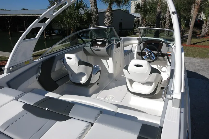 Slide: The Image of 2025 Chaparral 21 SSi Outboard boat interior with modern seating and steering wheel. - 4