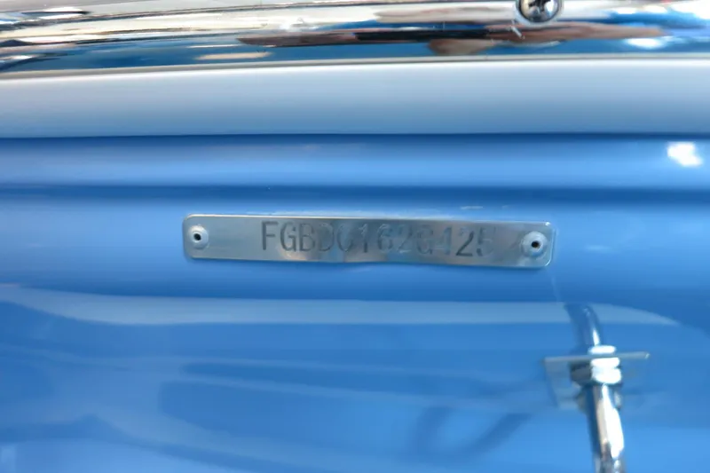 Slide: The Image of 2025 Chaparral 21 SSi Outboard boat identification plate on blue hull. - 41