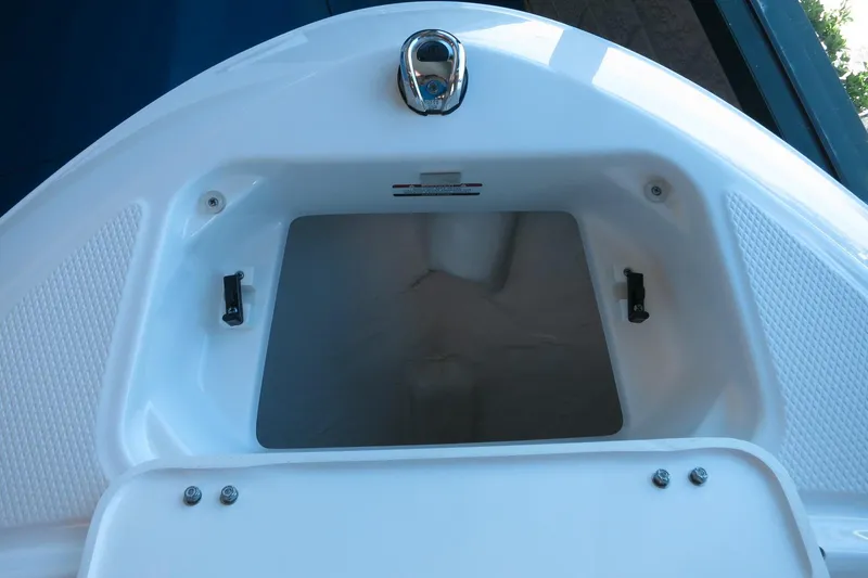 Slide: The Image of 2025 Chaparral 21 SSi Outboard boat storage compartment, open and empty. - 45