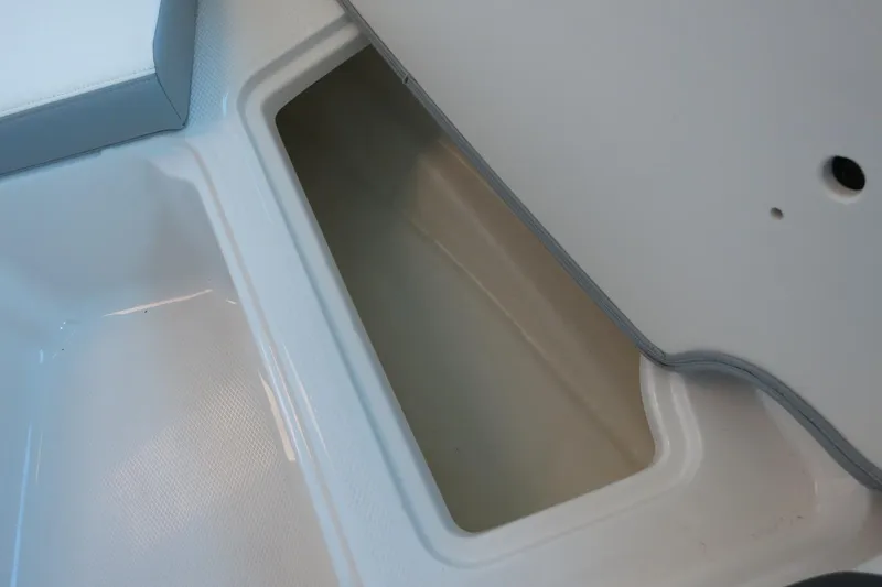 Slide: The Image of 2025 Chaparral 21 SSi Outboard storage compartment, open and empty. - 47