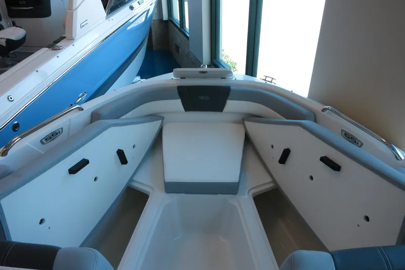Slide: The Image of 2025 Chaparral 21 SSi Outboard boat interior with seating and storage compartments. - 48