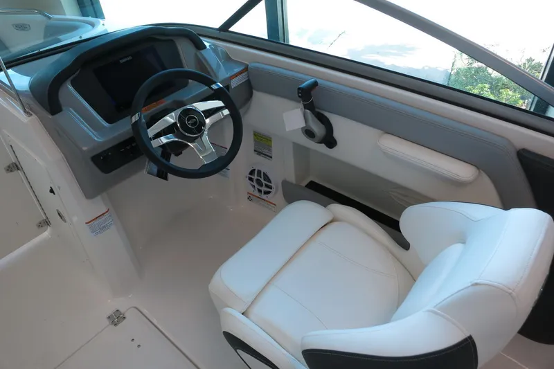 Slide: The Image of 2025 Chaparral 21 SSi Outboard helm with modern steering wheel and comfortable seating. - 52