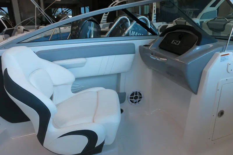 Slide: The Image of 2025 Chaparral 21 SSi Outboard interior with white seating and modern dashboard. - 54