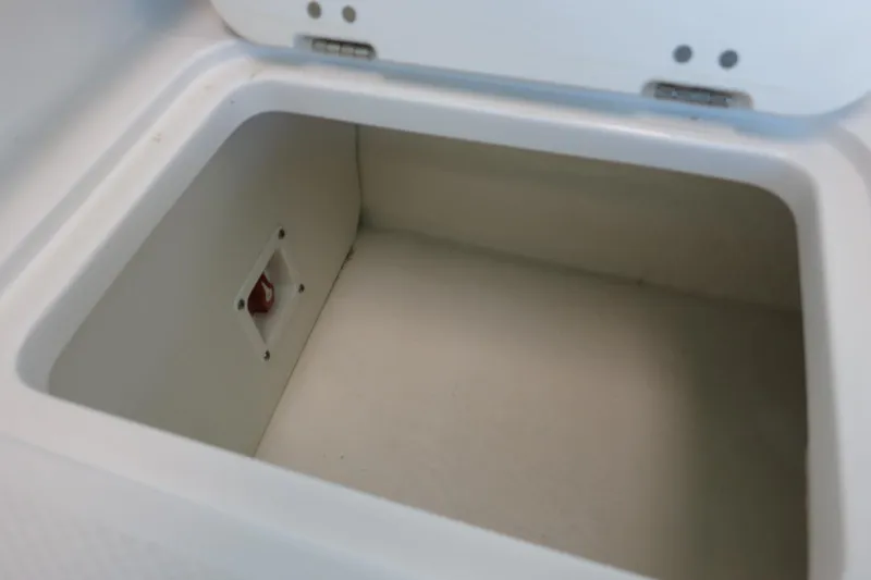 Slide: The Image of Storage compartment in 2025 Chaparral 21 SSi Outboard boat, featuring a white interior. - 57