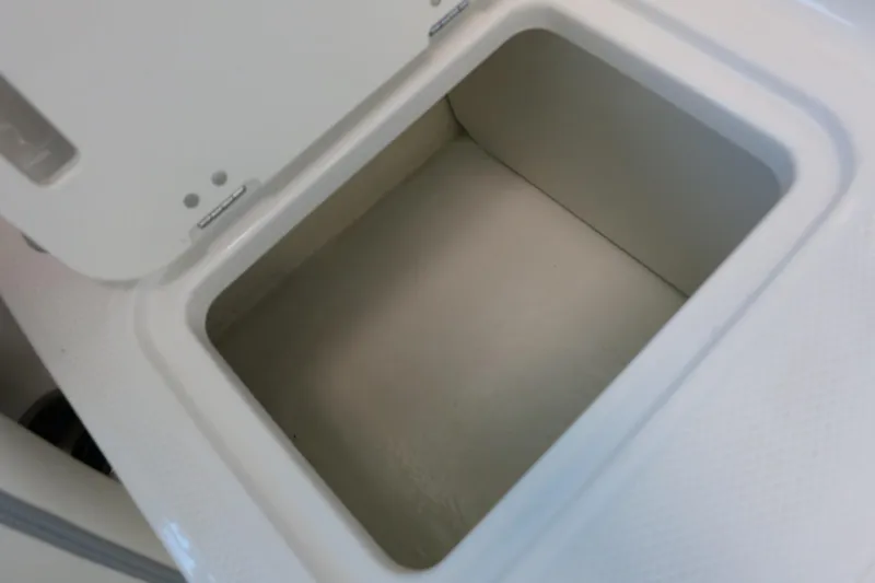 Slide: The Image of Storage compartment in 2025 Chaparral 21 SSi Outboard boat, open lid view. - 59