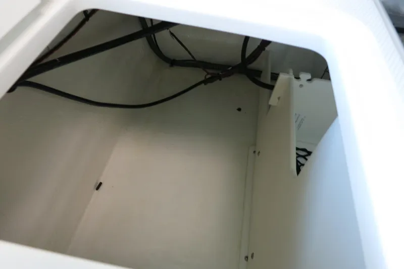Slide: The Image of Storage compartment of 2025 Chaparral 21 SSi Outboard boat, showing interior wiring. - 60