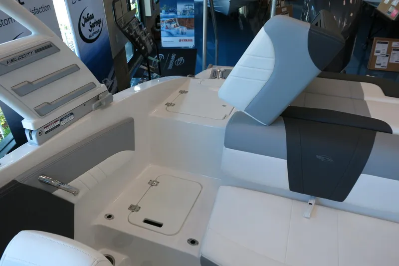 Slide: The Image of Interior of 2025 Chaparral 21 SSi Outboard boat, featuring sleek seating and storage compartments. - 64
