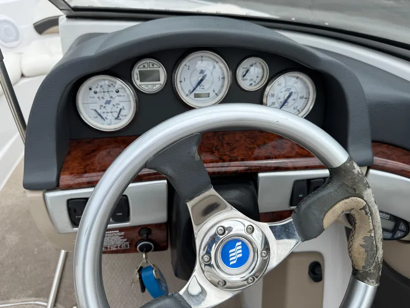 Slide: The Image of Dashboard of a 2005 Four Winns Horizon 200 boat with steering wheel and gauges. - 10