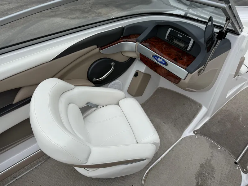 Slide: The Image of 2005 Four Winns Horizon 200 boat interior with white seating and wood-accented dashboard. - 12