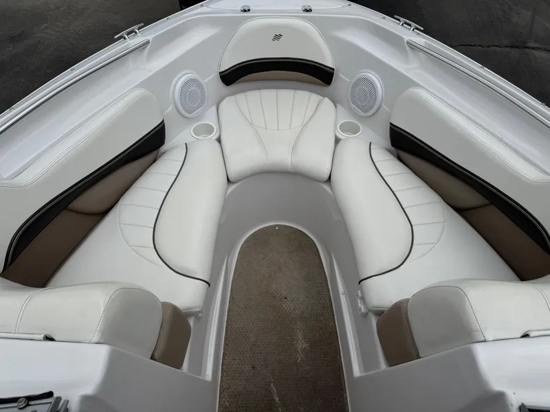 Slide: The Image of 2005 Four Winns Horizon 200 boat interior with white cushioned seating and cup holders. - 13