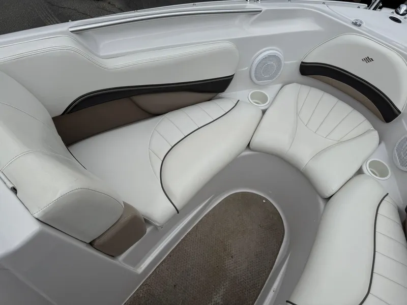 Slide: The Image of 2005 Four Winns Horizon 200 boat interior with white cushioned seating and cup holders. - 14