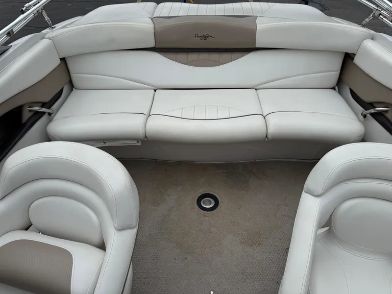 Slide: The Image of 2005 Four Winns Horizon 200 boat interior with white leather seating and carpeted floor. - 16