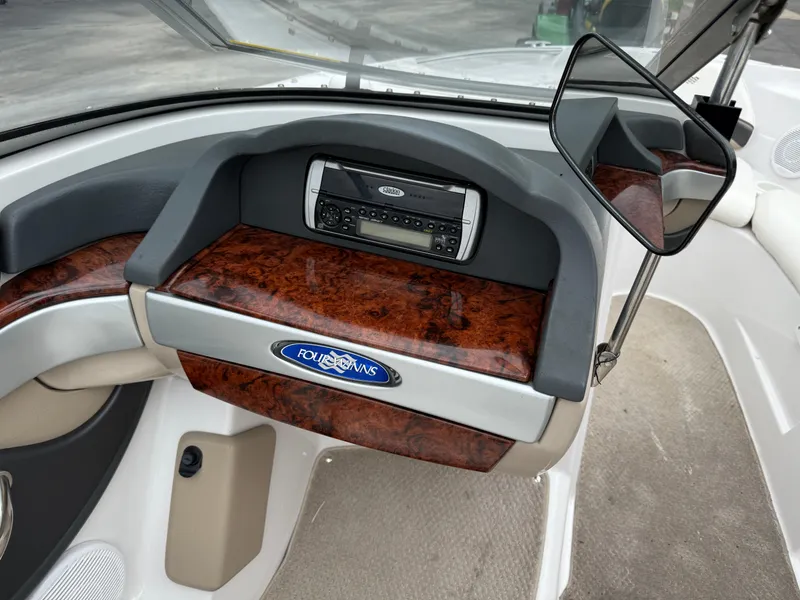 Slide: The Image of 2005 Four Winns Horizon 200 dashboard with wood accents and stereo system. - 17