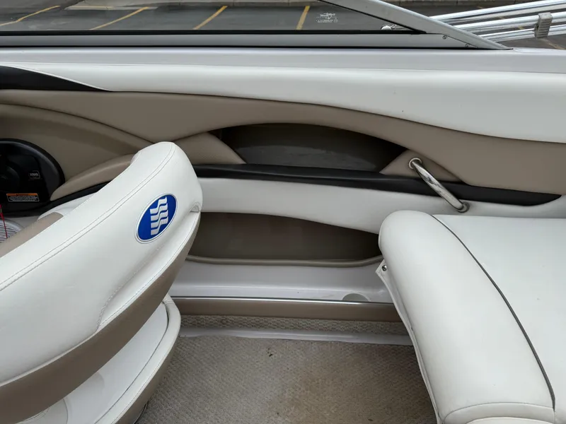 Slide: The Image of Interior of a 2005 Four Winns Horizon 200 boat, featuring white and beige seating. - 20