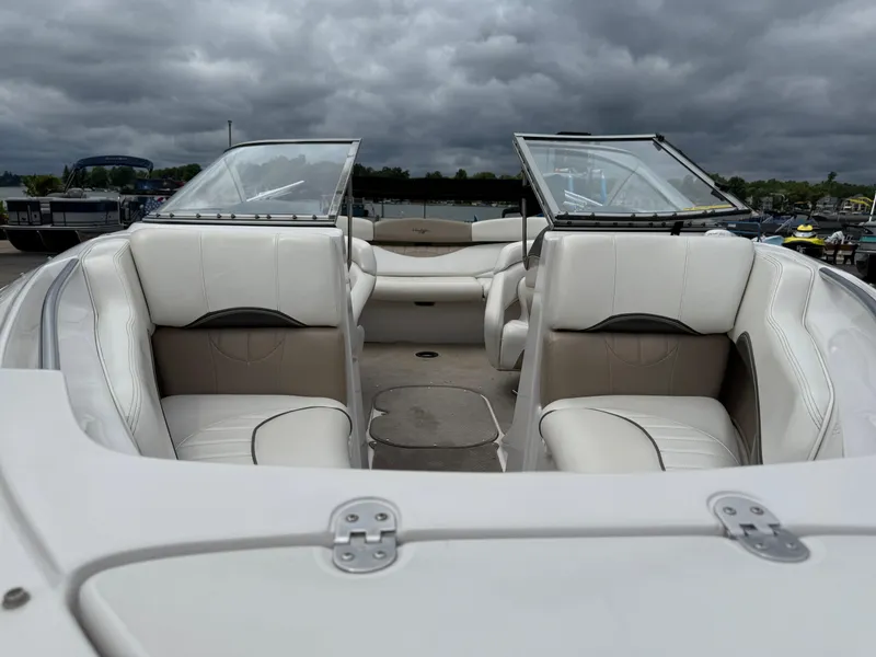 Slide: The Image of 2005 Four Winns Horizon 200 boat interior with white seating under cloudy skies. - 7