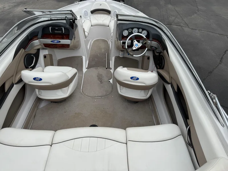 Slide: The Image of 2005 Four Winns Horizon 200 boat interior with white seating and dashboard controls. - 8