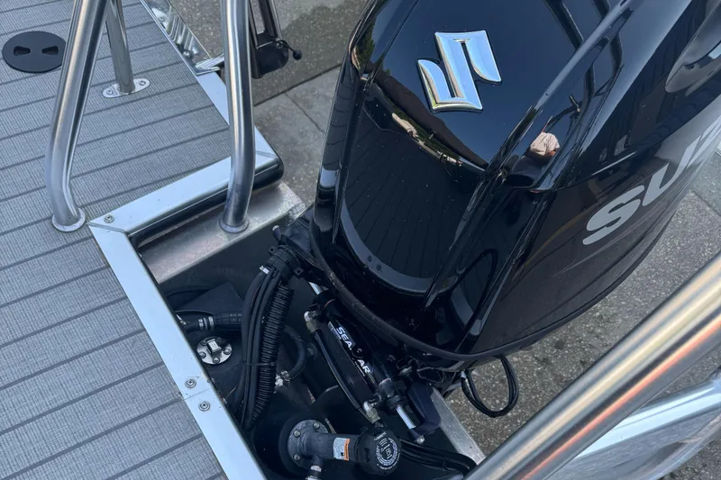 Slide: The Image of 2023 Bentley Pontoons 250 Elite Admiral with Suzuki outboard motor, docked on a pontoon. - 3