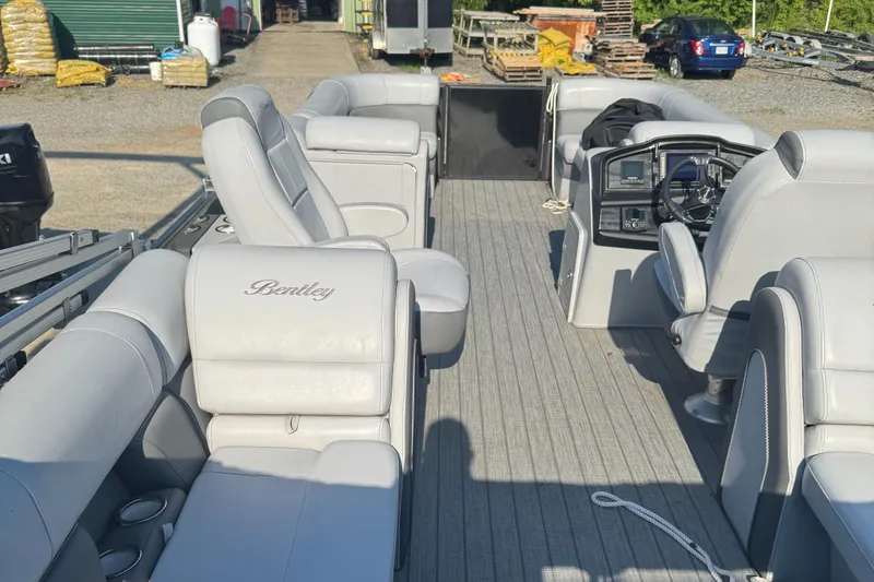 Slide: The Image of 2023 Bentley Pontoons 250 Elite Admiral interior with luxurious seating and modern dashboard. - 7