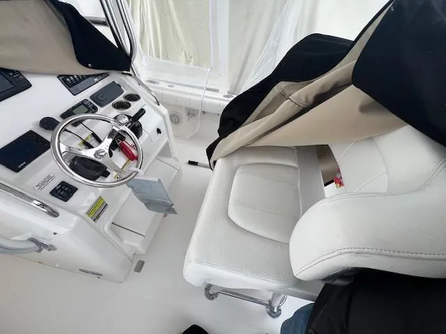 Slide: The Image of Interior of a 2015 Regulator 23 Forward Seating boat, featuring helm and seating area. - 23