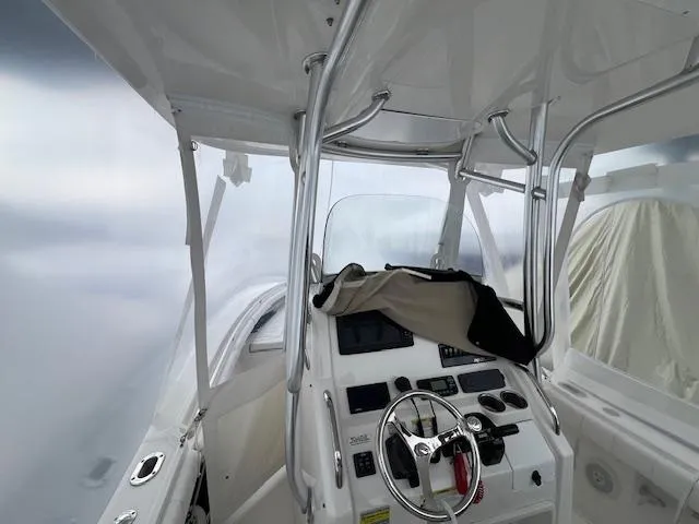 Slide: The Image of 2015 Regulator 23 Forward Seating boat interior with steering wheel and control panel. - 24