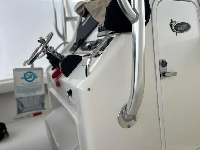 Slide: The Image of 2015 Regulator 23 Forward Seating boat interior with steering wheel and control panel. - 5