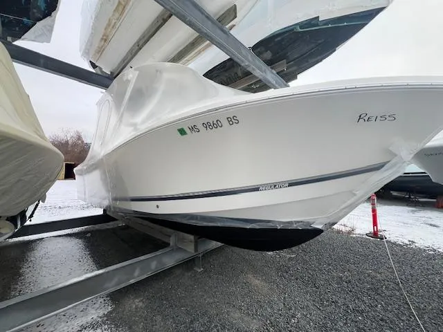 Slide: The Image of 2015 Regulator 23 Forward Seating boat stored on a rack in a marina. - 6