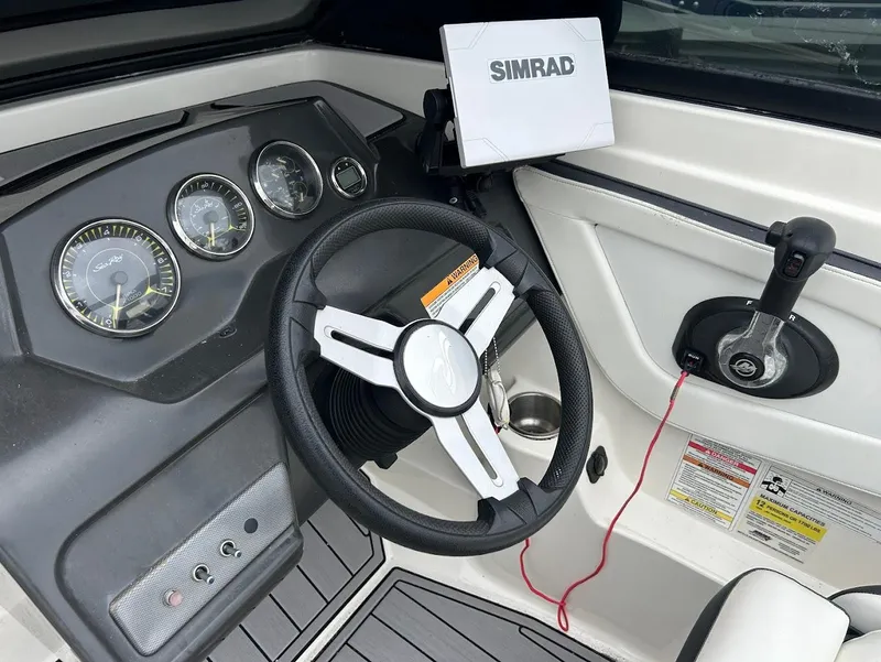 Slide: The Image of 2016 Sea Ray SPX 210 dashboard with steering wheel and Simrad display. - 10