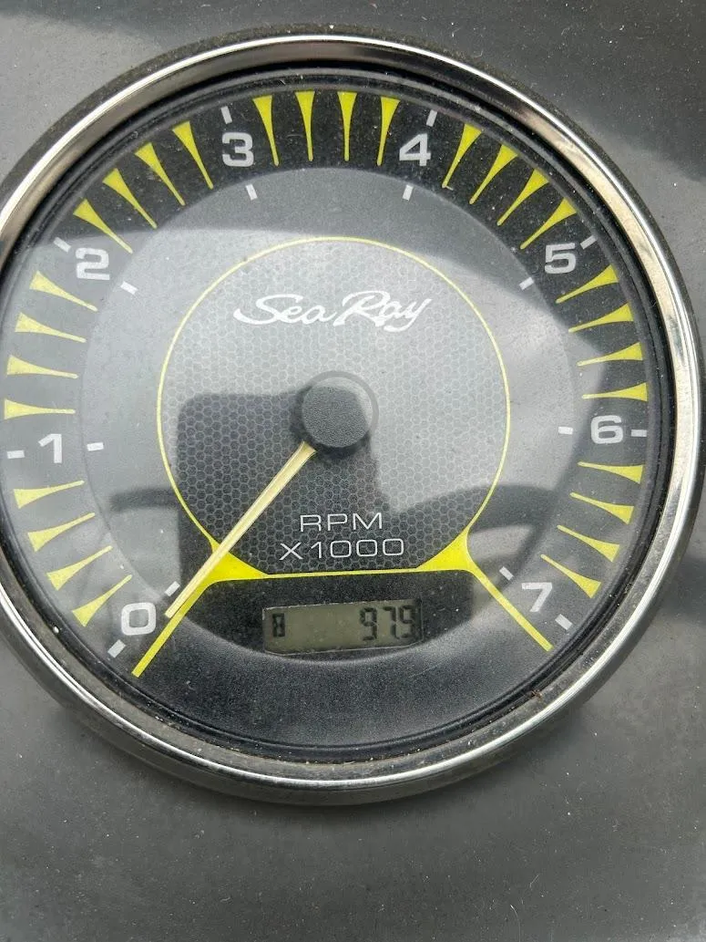 Slide: The Image of Close-up of a Sea Ray SPX 210 tachometer showing RPM at 975. - 11