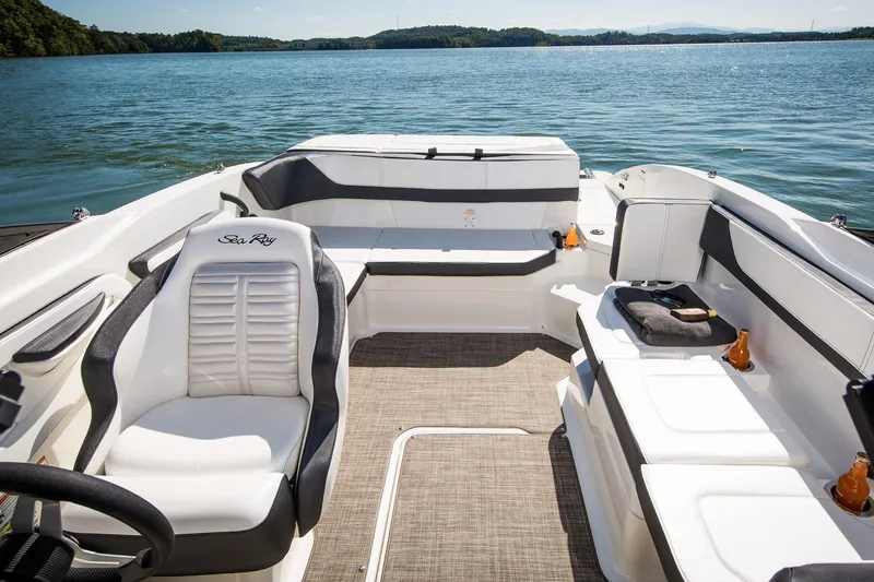 Slide: The Image of Manufacturer Provided Image: 2016 Sea Ray SPX 210 boat interior with white seating on a lake. - 18