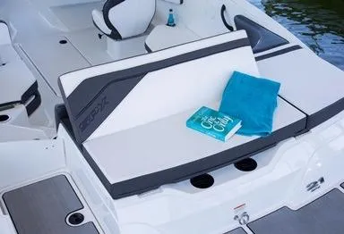 Slide: The Image of Manufacturer Provided Image: Sea Ray SPX 210 2016 boat interior with seating, book, and towel. - 20