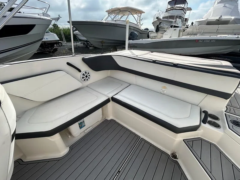 Slide: The Image of 2016 Sea Ray SPX 210 boat interior with white seating and gray flooring. - 5